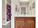 Bathroom with granite counter top and shower with pink floral curtain at 6370 Stillwood Ln, Cumming, GA 30041