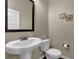 Charming half bath features a pedestal sink, white toilet, and neutral wall color at 6370 Stillwood Ln, Cumming, GA 30041
