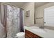 Bathroom features a vanity, granite countertop, and decorative shower curtain at 6370 Stillwood Ln, Cumming, GA 30041