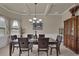Elegant dining room boasts coffered ceilings, wainscoting, and a dark wood dining set at 6370 Stillwood Ln, Cumming, GA 30041