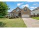 Charming brick two-story home with a well-manicured lawn and a two-car garage at 6370 Stillwood Ln, Cumming, GA 30041