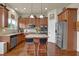 Bright kitchen features stainless steel appliances, granite counters, kitchen island, and hardwood floors at 6370 Stillwood Ln, Cumming, GA 30041