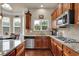 Well-appointed kitchen featuring stainless steel appliances, granite countertops, and hardwood flooring at 6370 Stillwood Ln, Cumming, GA 30041