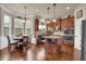 Well-lit kitchen featuring an island with bar seating, hardwood floors, and stainless steel appliances at 6370 Stillwood Ln, Cumming, GA 30041