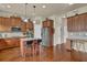 Spacious kitchen with granite countertops, stainless steel appliances, and an island with barstool seating at 6370 Stillwood Ln, Cumming, GA 30041