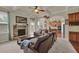 Cozy living room with a stone fireplace, beamed ceilings, and view to kitchen at 6370 Stillwood Ln, Cumming, GA 30041