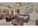 Spacious living room showing open floorplan with cozy seating and view to kitchen and staircase at 6370 Stillwood Ln, Cumming, GA 30041