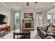 Comfortable living room featuring a stone fireplace and coffered ceilings at 6370 Stillwood Ln, Cumming, GA 30041