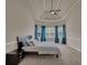 Cozy bedroom showcasing a tray ceiling, plush carpet, and sun-drenched windows at 6370 Stillwood Ln, Cumming, GA 30041