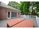Backyard deck features a hot tub, brick house and outdoor living space for relaxing and entertaining at 830 Cramac Dr, Lawrenceville, GA 30046
