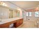 Bathroom with floral wallpaper and a large vanity, featuring double sinks, tile floors, and natural light from the windows at 830 Cramac Dr, Lawrenceville, GA 30046