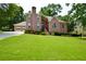Charming two-story brick home featuring a well-manicured lawn and a three-car garage at 830 Cramac Dr, Lawrenceville, GA 30046