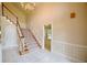 Grand foyer with marble flooring, a staircase, and wainscoting, creating an inviting entrance to the home at 830 Cramac Dr, Lawrenceville, GA 30046