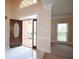 Bright foyer with marble tile floor, a decorative front door, and traditional wall trim details at 830 Cramac Dr, Lawrenceville, GA 30046