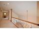 Bright hallway with carpet, decorative lighting, and access to other rooms at 830 Cramac Dr, Lawrenceville, GA 30046