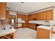 Traditional kitchen with oak cabinets, white countertops, and tile flooring with access to living room at 830 Cramac Dr, Lawrenceville, GA 30046