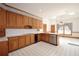 Traditional kitchen with oak cabinetry, white countertops, and white tile flooring at 830 Cramac Dr, Lawrenceville, GA 30046