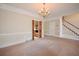 Large living room showcasing chandelier, pillars, staircase, and an open layout at 830 Cramac Dr, Lawrenceville, GA 30046