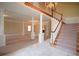 Spacious living room with pillars, neutral carpet, chandeliers and a staircase at 830 Cramac Dr, Lawrenceville, GA 30046