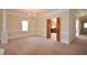 Open-concept living room showcasing elegant chandelier, pillars, and access to other rooms at 830 Cramac Dr, Lawrenceville, GA 30046