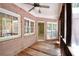 Covered patio with brick siding and wood flooring, featuring windows and screens that offer an outdoor living space at 830 Cramac Dr, Lawrenceville, GA 30046
