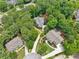 A luxurious home nestled in a lush, green neighborhood, as seen from above, featuring mature trees and manicured lawns at 120 Forest Breeze Cv, Alpharetta, GA 30022