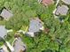 Aerial view of a luxurious home surrounded by lush green trees and manicured landscaping in an upscale neighborhood at 120 Forest Breeze Cv, Alpharetta, GA 30022