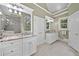Bright bathroom featuring granite countertops, dual sinks, and ample cabinet space at 120 Forest Breeze Cv, Alpharetta, GA 30022