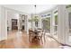 Bright breakfast nook featuring hardwood floors, a bay window, and a stylish light fixture at 120 Forest Breeze Cv, Alpharetta, GA 30022