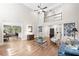 Open-concept living room with hardwood floors, and view of the dining room at 120 Forest Breeze Cv, Alpharetta, GA 30022