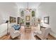Bright living room with fireplace, tall windows, and stylish furniture at 120 Forest Breeze Cv, Alpharetta, GA 30022