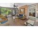 Inviting screened porch with comfortable seating, brick accents, and serene outdoor views at 120 Forest Breeze Cv, Alpharetta, GA 30022