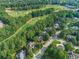 Overhead shot of luxury homes surrounded by mature trees, manicured lawns, and a golf course in the distance at 1055 Beacon Hill Xing, Alpharetta, GA 30005