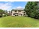 Expansive backyard with lush green lawn, patio area for entertaining, and mature trees at 1055 Beacon Hill Xing, Alpharetta, GA 30005