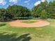 Well-maintained baseball field featuring lush green grass, a dirt infield, and chain-link fencing at 1055 Beacon Hill Xing, Alpharetta, GA 30005