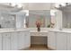 Bathroom featuring double vanity with large mirrors and neutral tile flooring, offering ample space at 1055 Beacon Hill Xing, Alpharetta, GA 30005