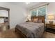 A bedroom with a rustic headboard and neutral bedding at 1055 Beacon Hill Xing, Alpharetta, GA 30005