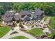 Stunning aerial view of the clubhouse with manicured lawns, outdoor seating, and lush landscaping at 1055 Beacon Hill Xing, Alpharetta, GA 30005