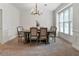 A formal dining room with modern chandelier and neutral decor at 1055 Beacon Hill Xing, Alpharetta, GA 30005
