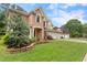 Traditional brick home with well-manicured lawn, landscaping and three car garage at 1055 Beacon Hill Xing, Alpharetta, GA 30005