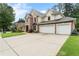 Brick and siding house with a three-car garage and a spacious driveway, perfect for a growing Gathering at 1055 Beacon Hill Xing, Alpharetta, GA 30005