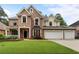 Charming brick two-story home with well-manicured lawn, inviting curb appeal, and a three car garage at 1055 Beacon Hill Xing, Alpharetta, GA 30005