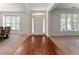 Inviting foyer with hardwood floors transitioning to carpet, showcasing an elegant entrance at 1055 Beacon Hill Xing, Alpharetta, GA 30005