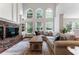 Sun-filled living room featuring vaulted ceilings, large windows, and a comfortable seating area at 1055 Beacon Hill Xing, Alpharetta, GA 30005