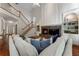 Open-concept living room with vaulted ceilings, a stone fireplace, and hardwood floors at 1055 Beacon Hill Xing, Alpharetta, GA 30005