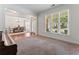 Open living room with hardwood and carpet flooring with large windows at 1055 Beacon Hill Xing, Alpharetta, GA 30005