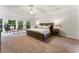 A large main bedroom featuring a tray ceiling and a sitting area with lots of natural light at 1055 Beacon Hill Xing, Alpharetta, GA 30005