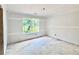 A bright bedroom features fresh drywall, and a large window looking out on the natural beauty at 133 West Lake Blvd, Carrollton, GA 30116
