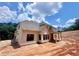 A two-story house featuring windows and unfinished siding sitting on a partially completed lot at 133 West Lake Blvd, Carrollton, GA 30116