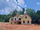 Two-story home featuring a gable roof design, light yellow siding, black trim, and a double-door entry at 133 West Lake Blvd, Carrollton, GA 30116